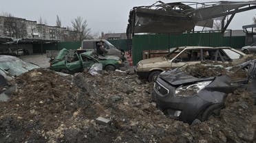 A local resident inspects destroyed cars following a missile attack in the town of Selydove, Donetsk region, on February 8, 2024, amid the Russian invasion of Ukraine. (Photo by Genya SAVILOV / AFP)