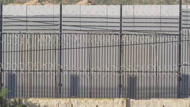 A border wall topped with concertina wire, near Rafah border, Egypt, December 16, 2023 is seen in this screen grab taken from a handout video. (Reuters)