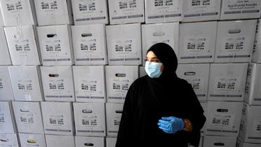 Volunteer clad in face masks and latex gloves take part in a charity campaign led by Dubai's ruler Sheikh Mohammed bin Rashid al-Maktoum to deliver meals to those who have lost their income due to the COVID-19 coronavirus crisis, at a distribution centre in the Gulf emirate on May 3, 2020. (AFP)