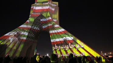 Azadi (Freedom) Tower is illuminated with pictures of Iranian late supreme leader Ayatollah Ruhollah Khomeini and Iran's national flag during a ceremony of the 45th anniversary of the Islamic Revolution, in Tehran, February 10, 2024. (Photo by AFP)