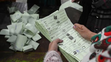 Election officials count ballot papers after polls closed at a polling station during Pakistan national election in Lahore on February 8, 2024. (AFP)