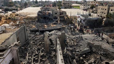 Palestinians inspect the damage amid the rubble of a building where two hostages were reportedly held before being rescued during an operation by Israeli security forcess in Rafah, on the southern Gaza Strip on February 12, 2024, amid ongoing battles between Israel and the militant group Hamas. (AFP)