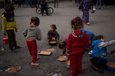 Palestinian kids receive free food in Rafah, Gaza Strip, Feb. 23, 2024. (AP)