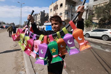 A displaced Palestinian child sells handmade Ramadan lanterns in Rafah in the southern Gaza Strip on March 8, 2024, amid the ongoing conflict between Israel and Hamas militants. (AFP)