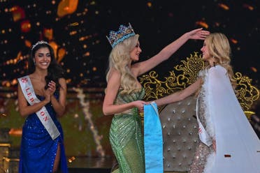 Lebanese Yasmina Zaytoun (L) applauds as Miss World 2022 Polish Karolina Bielawska (C) greets Czech Republic Krystyna Pyszkova (R) and attend in the grand finale of the 71st Miss World pageant at Jio World Convention Centre, in Mumbai, on March 9, 2024. (AFP)