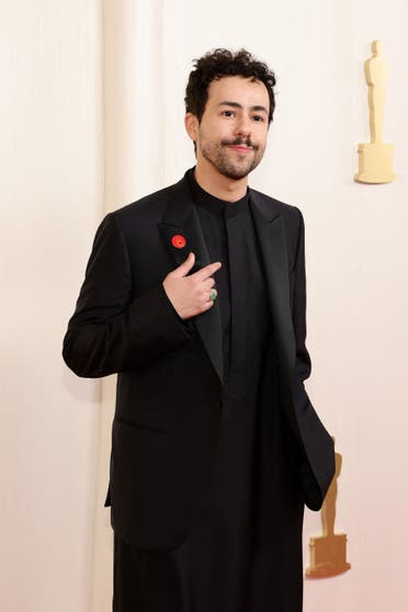 Ramy Youssef wears an Artists4Ceasefire pin, calling for de-escalation and ceasefire in Gaza and Israel, as he attends the 96th Annual Academy Awards at the Dolby Theatre in Hollywood, California on March 10, 2024. (AFP)