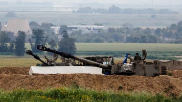 An Israeli soldier stands in an artillery unit at a military post near the Israel-Gaza border, amid the ongoing conflict between Israel and Hamas, in Israel on March 14, 2024. (Reuters)
