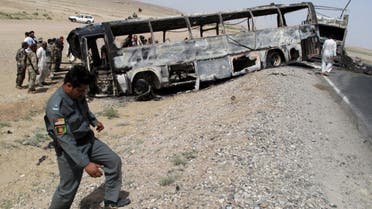 Traffic police officials inspect the site where a passenger bus collided with a fuel tanker truck in Kandahar province on April 26, 2013. (File photo: AFP)