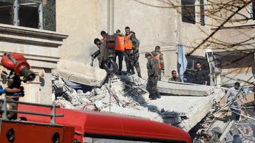 Security and emergency personnel search the rubble of a building destroyed in a reported Israeli strike in Damascus on January 20, 2024. (AFP)