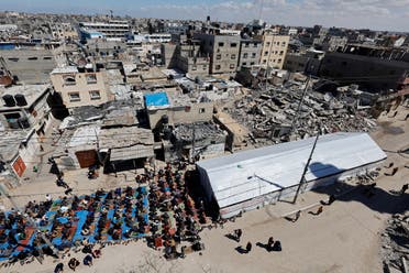Palestinians perform first Friday prayers during Ramadan near the ruins of a destroyed mosque, amid the ongoing conflict between Israel and the Palestinian group Hamas, in Rafah, in the southern Gaza Strip, March 15, 2024. (Reuters)