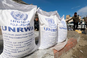 Displaced Palestinians wait to receive United Nations Relief and Works Agency (UNRWA) aid, in Rafah, in the southern Gaza Strip. (File photo: Reuters)