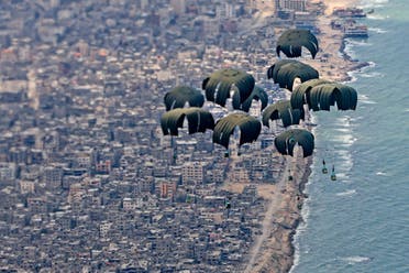 A handout picture taken and released by the British Ministry of Defence (MOD) on March 25, 2024 shows humanitarian aid being airdropped over Gaza from a RAF A400M aircraft. (AFP)