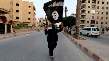 A member loyal to ISIS waves an ISIS flag in Raqqa, Syria, June 29, 2014. (Reuters)