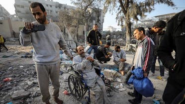 A man sits in a wheelchair as Palestinians inspect the damages at Al Shifa Hospital after Israeli forces withdrew from the hospital and the area around it following a two-week operation, amid the ongoing conflict between Israel and Hamas, in Gaza City April 1, 2024. REUTERS/Dawoud Abu Alkas