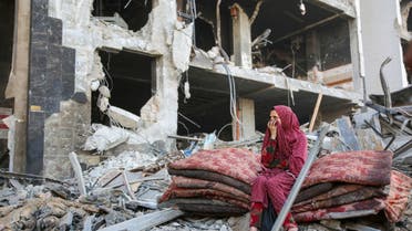 A Palestinian woman reacts as she sits amidst the rubble of Gaza's Al-Shifa hospital after the Israeli military withdrew from the complex housing the hospital on April 1, 2024, amid the ongoing battles Israel and the Hamas militant group. (AFP)