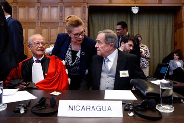 Nicaraguan Ambassador Carlos Jose Arguello Gomez and lawyer Alain Pellet sit in the courtroom, as Nicaragua is set to ask the International Court of Justice on Monday to order Berlin to halt military arms exports to Israel and reverse its decision to stop funding U.N. Palestinian refugee agency UNRWA, in The Hague, Netherlands, April 8, 2024. (Reuters)