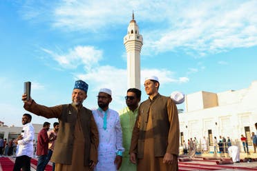 Muslim men take selfies after offering special morning prayers to start the Eid al-Fitr festival, which marks the end of the holy fasting month of Ramadan, at the Ali Bin Ali mosque in Doha on April 10, 2024. (AFP)