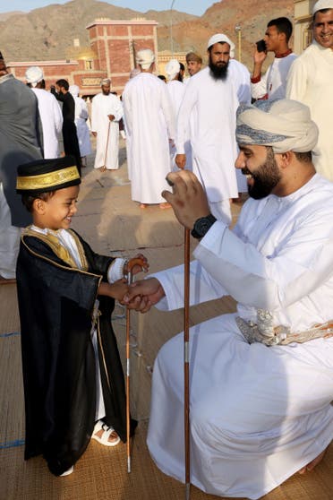 Muslim worshippers exchage greetings after the Eid al-Fitr morning prayer in the Fanja district in Oman's governorate of al-Dakhiliyah, about 65 kilometres southwest of the capital on April 10, 2024. (AFP)