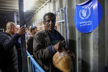 Displaced Palestinians line up to buy subsidised bread from a bakery in Gaza City on April 14, 2024, amid the ongoing conflict between Israel and the militant group Hamas. (AFP)