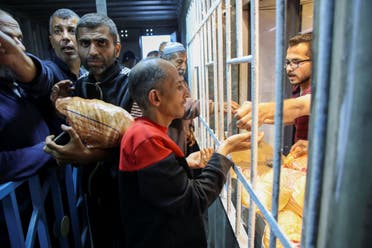 Palestinians line up to buy subsidised bread from a bakery in Gaza City on April 14, 2024, amid the ongoing conflict between Israel and the militant group Hamas. (AFP)