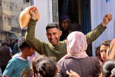 A Palestinian man reacts after buying subsidised bread outside a bakery in Gaza City on April 14, 2024, amid the ongoing conflict between Israel and the militant group Hamas. (AFP)