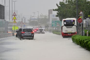 Vehicles drive on a flooded road during torrential rain in the Gulf Emirate of Dubai on April 16, 2024. (AFP)