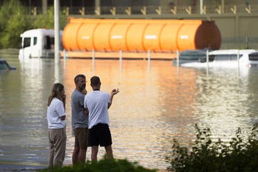 People look out at floodwater covering a major road in Dubai, United Arab Emirates, Wednesday, April 17, 2024. (AP)