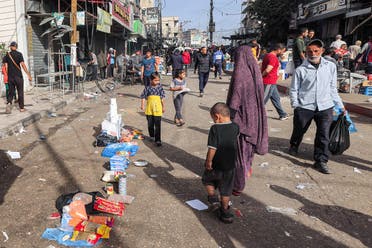 People walk along a market street in Rafah in the southern Gaza Strip on April 23, 2024 amid the ongoing conflict in the Palestinian territory between Israel and Hamas. (AFP)