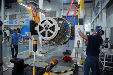 Engineers and workers stand inside Safran Aircraft Engines repair plant outside of Casablanca, Morocco, Thursday, April 18, 2024. (AP)