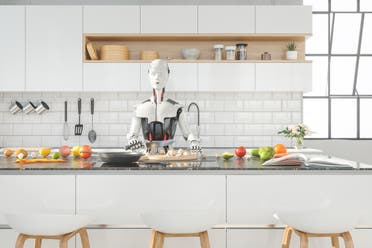 روبوت ذكاء اصطناعي يعد الطعام في المطبخ - تعبيرية من آيستوك