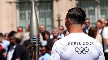 Paris Olympics 2024 - Torch Relay - Marseille, France - May 9, 2024 Torch bearer Matthieu Gudet holds the Olympic Torch during the relay. (Reuters)