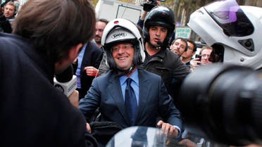Former socialist party head Francois Hollande, center, leaves on a motorbike after visiting a street market, Tuesday, Oct.11, 2011 in Paris. Hollande came in first in round one of the party's presidential primary last Sunday, with 39 percent of the vote. The party's current leader, Martine Aubry, came in second. The two are to face off in a televised debate Wednesday ahead of the Oct. 16 runoff. (AP Photo/Thibault Camus)