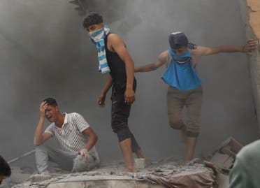  Palestinians gather at the site of an Israeli strike on a house, amid the Israel-Hamas conflict, in Deir Al-Balah, in the central Gaza Strip, on June 14, 2024. (Reuters)