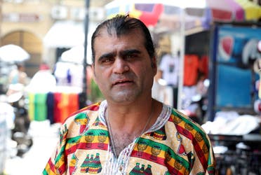 Shopkeeper Qassem Qarram attends an interview with Reuters at a market in the southern Lebanese port city of Sidon, Lebanon June 20, 2024. (Reuters)