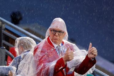 Prince Albert II of Monaco, wearing a raincoat, gives thumbs-up as delegations arrive at the Trocadero during the opening ceremony of the Paris 2024 Olympic Games. (Reuters)