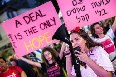 Protesters gather with signs demanding a hostage deal during a demonstration demanding action to free the Israeli hostages captive in the Gaza Strip. (AFP)