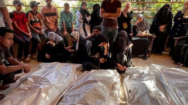 Mourners grieve next to the bodies of Palestinians killed in Israeli strikes, amid the Israel-Hamas conflict, at Al-Nasser Hospital in Khan Younis in the southern Gaza Strip, on August 28, 2024. (AFP) 