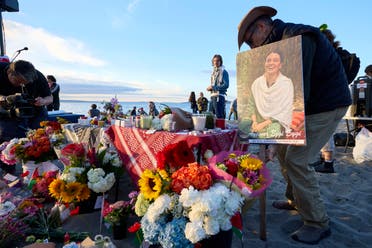 A photo is placed among flowers in memory of the death of the 26-year old Aysenur Ezgi Eygi at vigil on Alki Beach, killed recently in the occupied West Bank, Wednesday, Sept. 11, 2024, in Seattle. Eygi grew up in Seattle, attended Seattle Public Schools and graduated from the University of Washington. (AP Photo/John Froschauer)