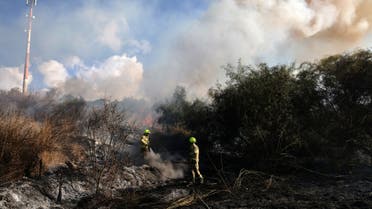 First responders put out a fire in an open in Lod near Tel Aviv, caused by a missile fired from Yemen on September 15, 2024. (AFP)
