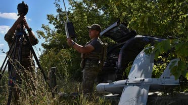 A soldier of Ukraine's National Guard 15th Brigade carries a reconnaissance drone Leleka on a wheat field to determine Russian positions near the front line in Zaporizhzhia region, Ukraine, Monday, July 29, 2024. (AP Photo/Andriy Andriyenko)