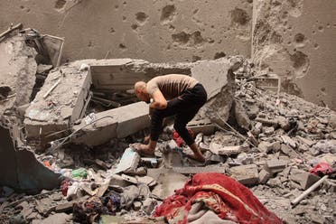 A man sifts through debris after a school used as shelter by displaced Palestinians was hit by an Israeli strike in the Shujaiya neighbourhood of Gaza City on September 18, 2024, amid the ongoing war between Israel and the militant group Hamas. (AFP)