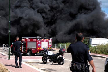 Israeli policemen stand next to smoke from a fire following incoming rockets from Lebanon to Israel in Bezet, northern Israel April 6, 2023. (Reuters)