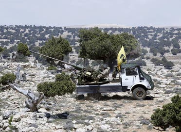 Lebanon's Hezbollah fighters rest on the back of a pick-up truck with an installed weapon in Khashaat, in the Qalamoun region in this file photo. (Reuters)