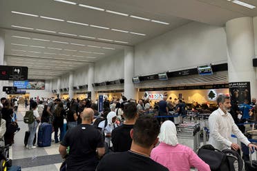 People line up at check-in counters at Rafik Hariri International airport in Beirut, Saturday, Sept. 28, 2024. (AP)