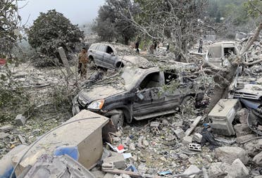 Lebanese army soldier stands near destroyed vehicles at a site damaged by an Israeli air strike in the Christian-majority region of Aitou in north Lebanon, the Lebanese health ministry said, October 14, 2024. (Reuters)