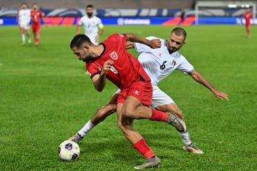 Jordan's Ali Orwan (front) and Palestine's Oday Kharoub fight for the ball during the 2026 FIFA World Cup Asian qualification football match between Jordan and Palestine at Kuala Lumpur Stadium in Kuala Lumpur on September 10, 2024. (AFP)