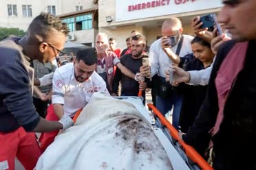 In this image made from an Associated Press video, medic Abed Al Aziz Bardini cries over the body of his mother after he realizes it's her, shouting in Arabic, Oh god, I swear she is my mother. I didn't know it was her, on Wednesday, Oct. 30, 2024, in Deir al-Balah on the Gaza Strip. (AP)