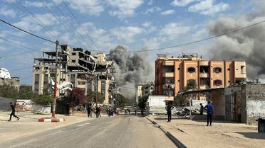 Palestinians watch as smoke rises following Israeli strikes, amid the ongoing conflict between Israel and Hamas, in Nuseirat in the central Gaza Strip, on November 1, 2024. (Reuters)