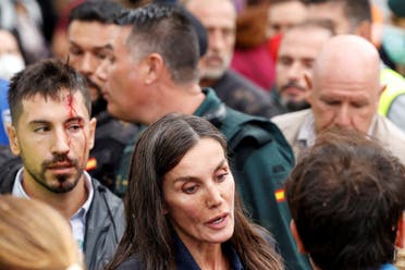 Spain's Queen Letizia speaks to people as she has mud on her face, following heavy rains that caused floods, in Paiporta, near Valencia, Spain, November 3, 2024. (Reuters)