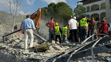 Rescuers use an excavator to search for survivors at the site of an Israeli airstrike that targeted the village of Almat north of Beirut on November 10, 2024. Lebanon's health ministry said the Israeli strike killed 20 people including three children. (Photo by Etienne TORBEY / AFP)